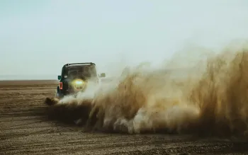 Truck kicking up plume of dust. Photo credit Bradley Dunn via Unsplash