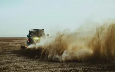 Truck kicking up plume of dust. Photo credit Bradley Dunn via Unsplash